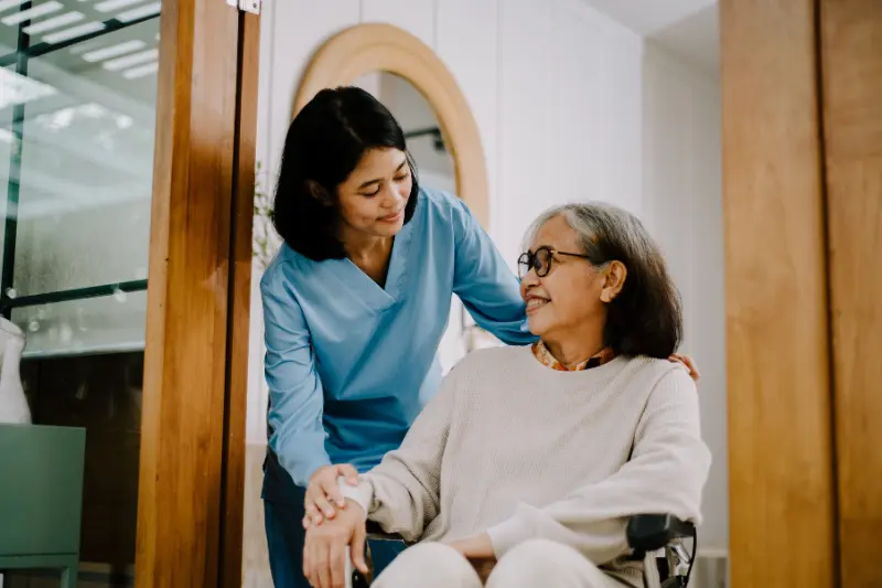 Caring_communities1 A carer looking after an senior lady in a wheel chair