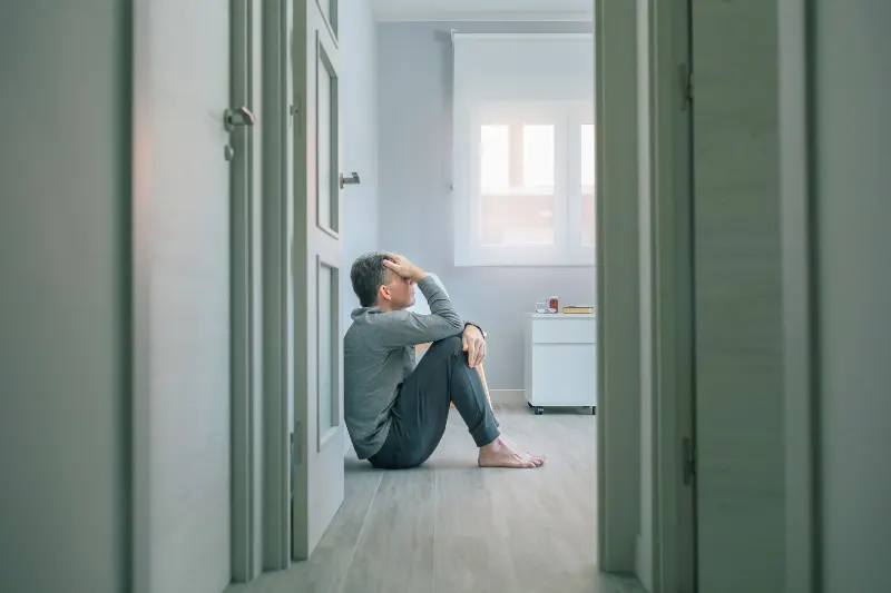 Feeling_hurtful1 A man sitting alone in his room